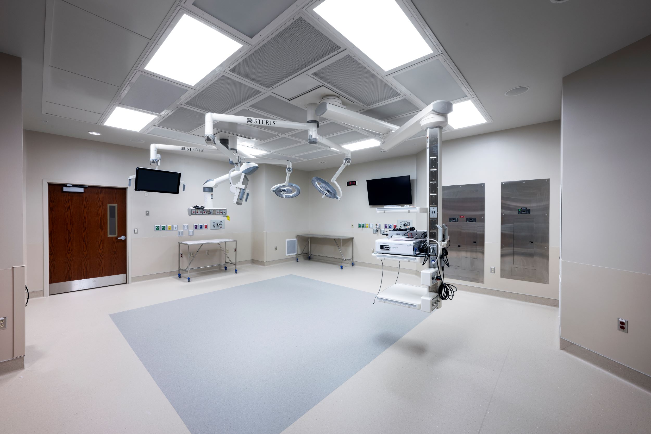 operating room with overhead lights and screens