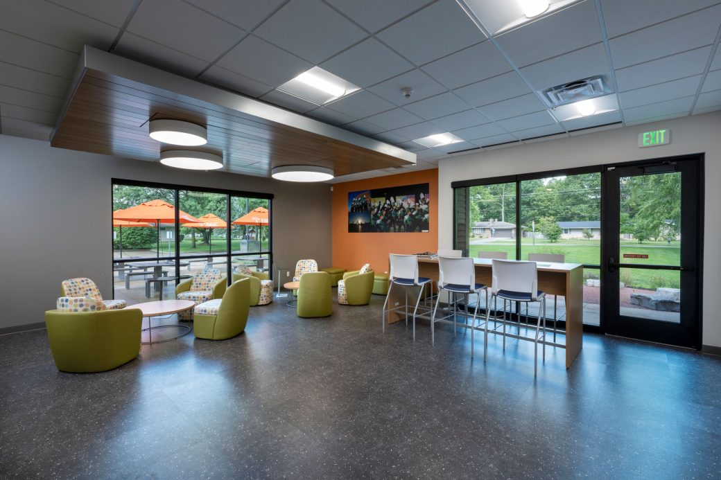 tables and lounge chairs near windows