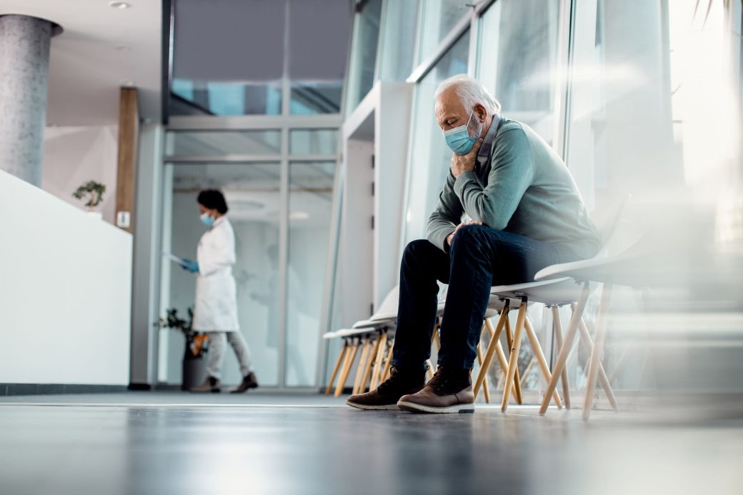 man with mask in hospital lobby